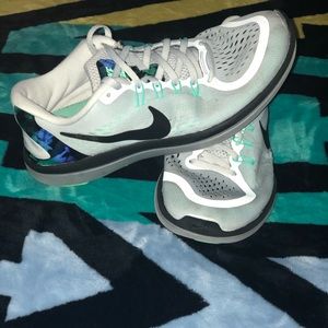 White and teal running shoes
